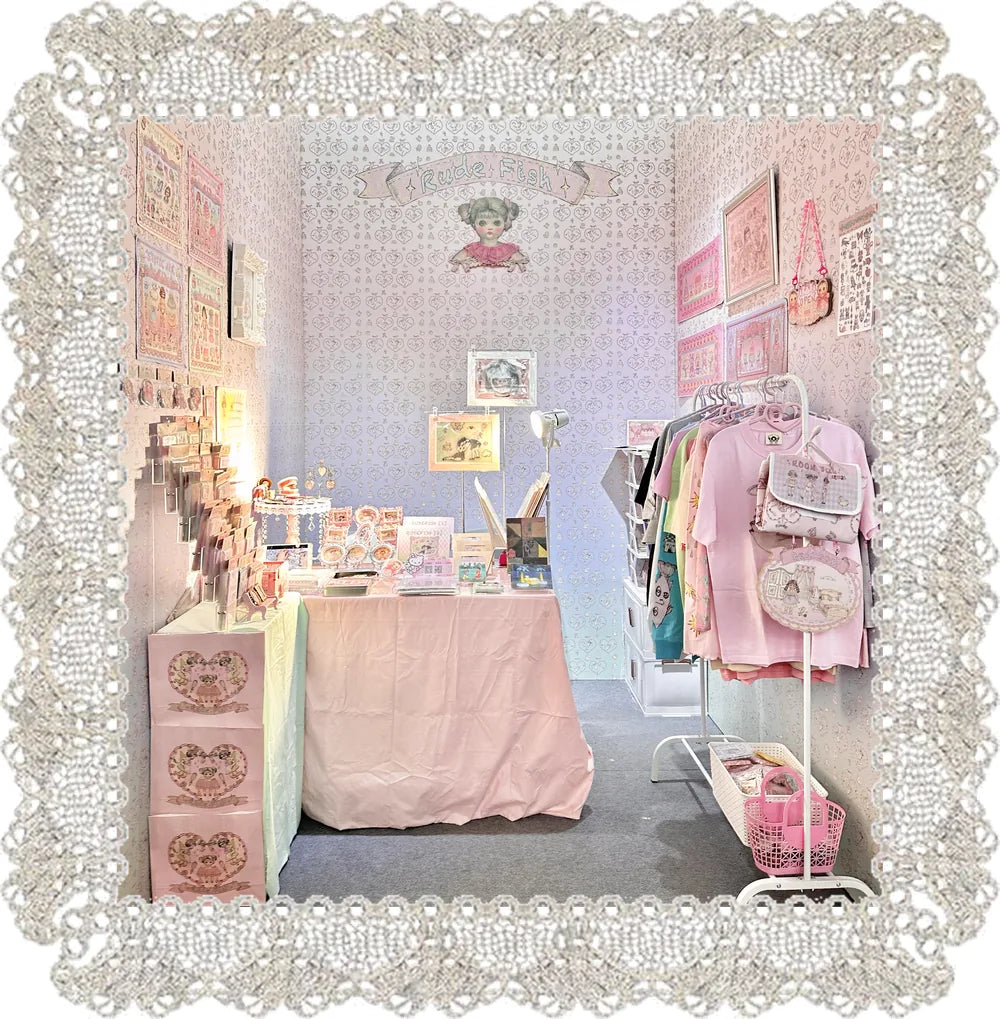 RudeFish market stand with prints, tees and paper-doll sheets
