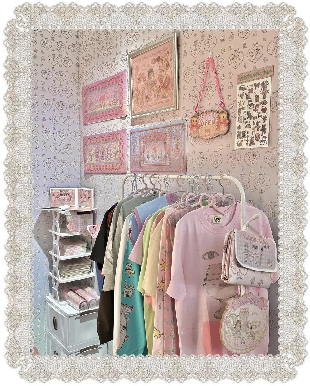 Framed RudeFish prints above a rail of printed tees